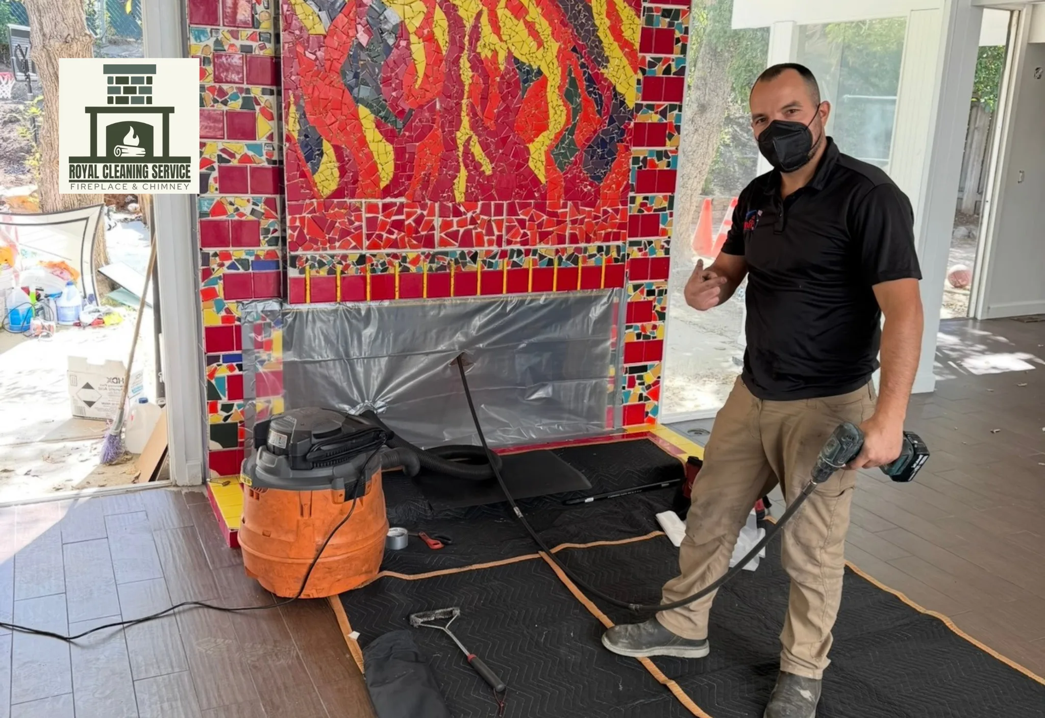 Fireplace cleaning Los Angeles — technician removing ash and soot from firebox interior during Royal Cleaning Service visit